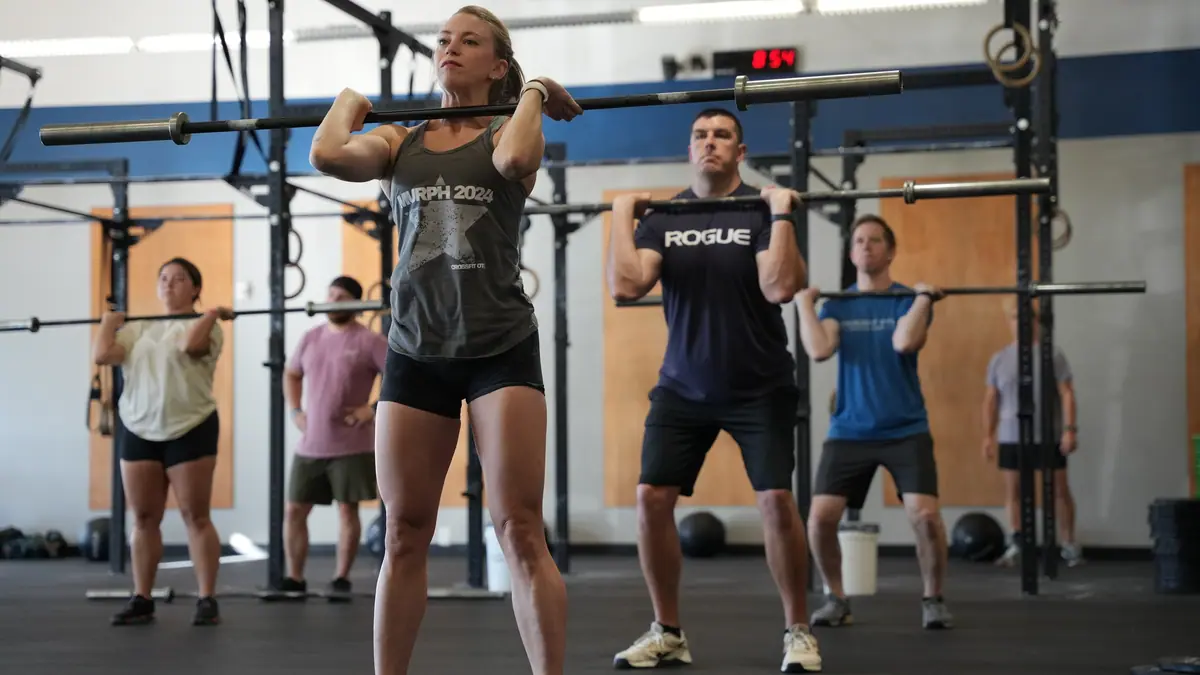 A CrossFit OTL class front squatting together