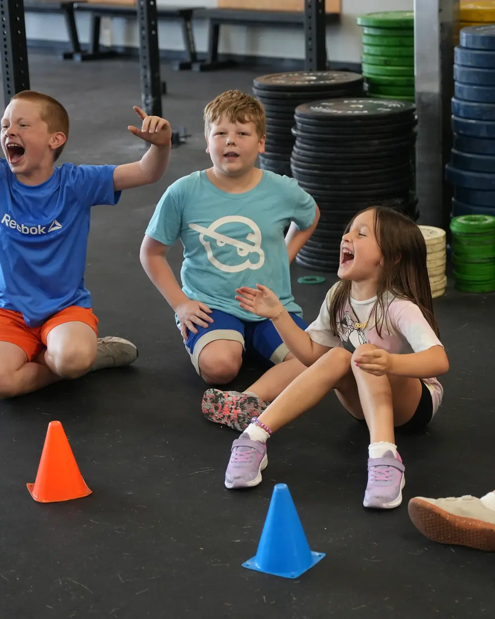 Kids cheering on the floor during a CrossFit OTL kids class