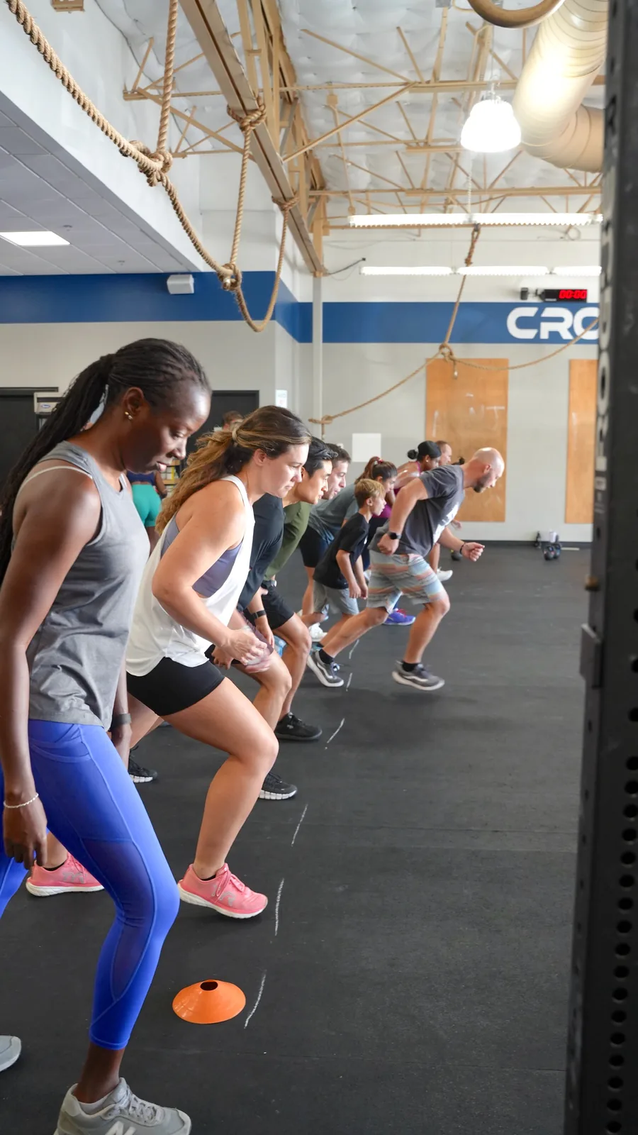 CrossFit OTL members warming up with bodyweight lunges