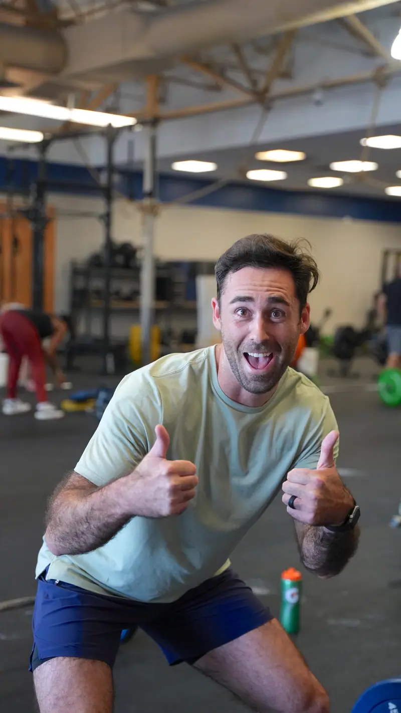 A CrossFit OTL member grinning and giving a thumbs up mid-class