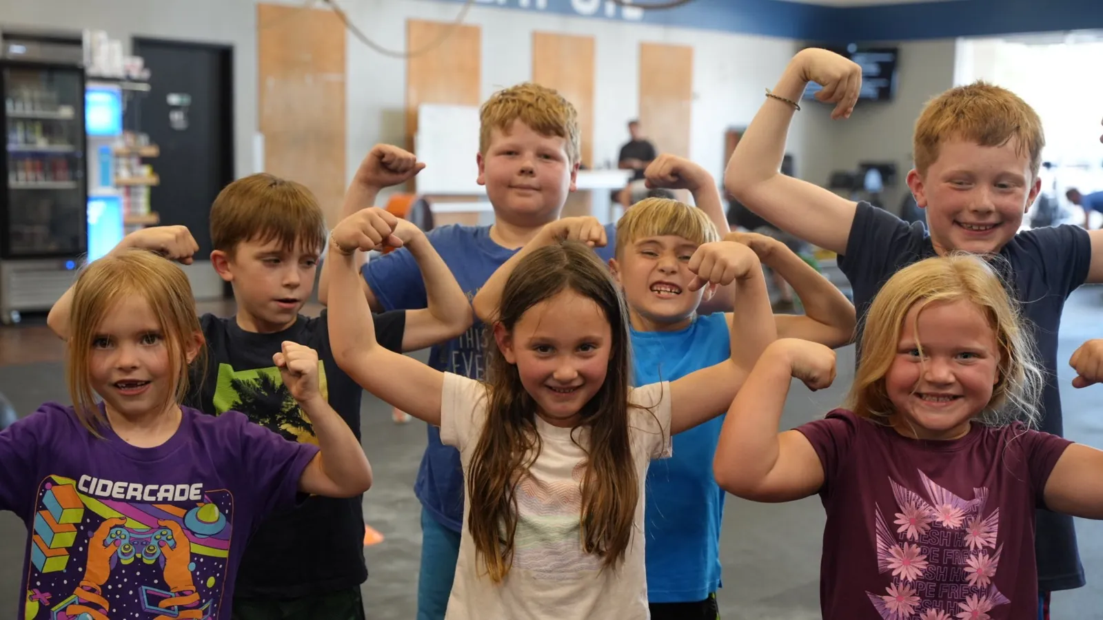 Kids in the CrossFit OTL youth class flexing for the camera